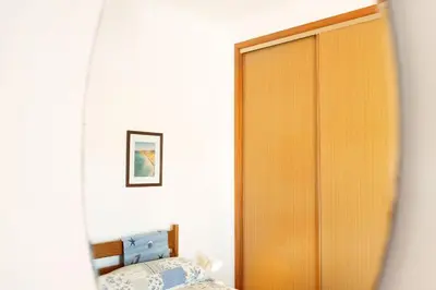 a bedroom with a bed and a large mirror at Casa Do Poço in Budens