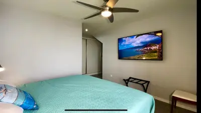 a bedroom with a bed and a ceiling fan at Ocean Front in Paul do Mar