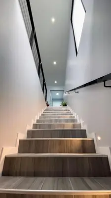 a staircase in a building with wooden steps at Ocean Front in Paul do Mar