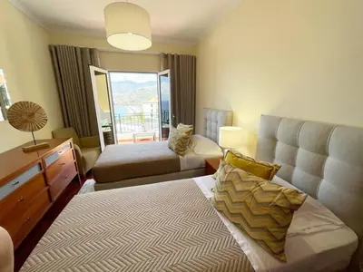 a hotel room with a bed and a couch at Seaview Apartment walking to the Beach in Funchal
