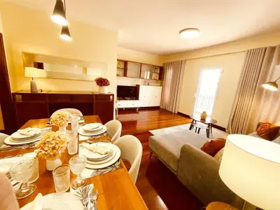a living room with a table and a couch at Seaview Apartment walking to the Beach in Funchal