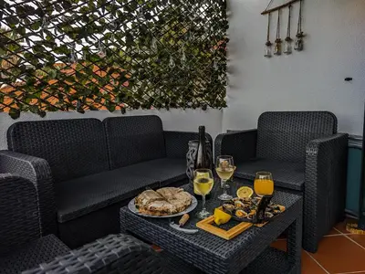 a table with a tray of food and glasses of wine at Casa Ascenção, vista mar Madeira in Funchal