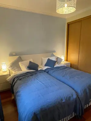 a large bed with blue sheets in a bedroom at Beach&Comfort Cozy Apartment by the Ocean in Funchal