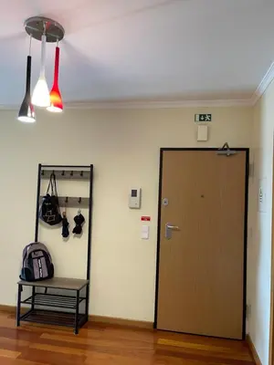 a room with a door and a table with a backpack at Beach&Comfort Cozy Apartment by the Ocean in Funchal