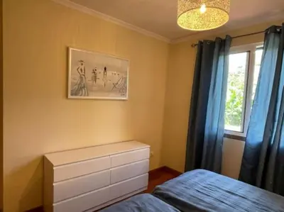 a bedroom with a bed and a picture on the wall at Beach&Comfort Cozy Apartment by the Ocean in Funchal
