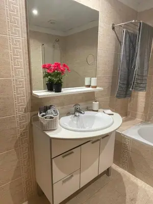 a bathroom with a sink and a mirror and a tub at Beach&Comfort Cozy Apartment by the Ocean in Funchal
