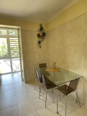 a dining room with a glass table and chairs at Beach&Comfort Cozy Apartment by the Ocean in Funchal