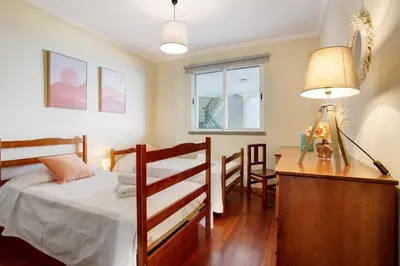 a bedroom with a bed with two towels on it at Apartamento Fénix Garajau in Caniço