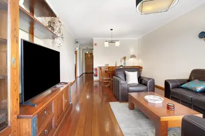 a living room with a large flat screen tv at Apartamento Fénix Garajau in Caniço