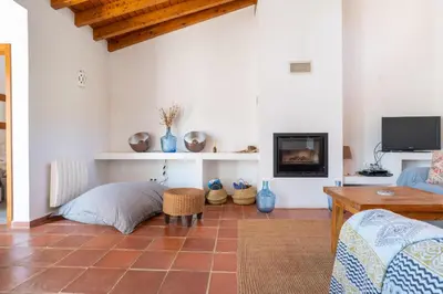 a living room with a bed and a tv at Casa Mira Vale - Calm Country House by Lisbeyond in Aljezur