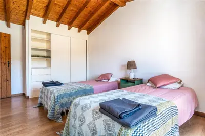 two beds in a room with a room with a door at Casa Mira Vale - Calm Country House by Lisbeyond in Aljezur