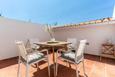 a dining room table and chairs on a patio at Casa Mira Vale - Calm Country House by Lisbeyond in Aljezur