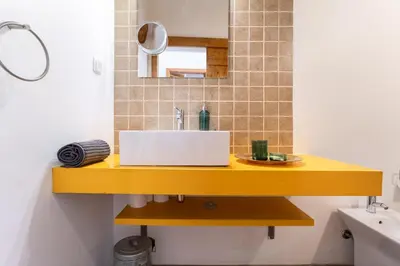 a bathroom with a yellow counter with a sink at Casa Mira Vale - Calm Country House by Lisbeyond in Aljezur