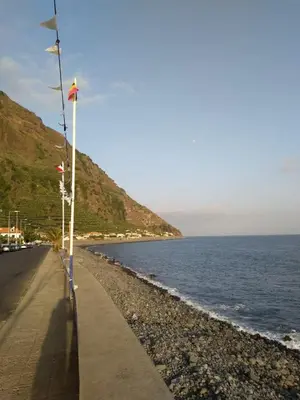 a road next to a body of water at Maresia's House in Madalena do Mar