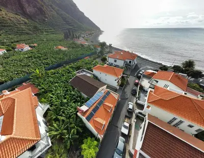 an aerial view of a village next to the ocean at Maresia's House in Madalena do Mar