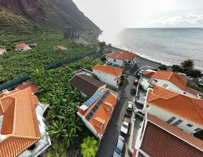 an aerial view of a village next to the ocean at Maresia's House in Madalena do Mar