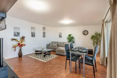 a living room with a table and a couch at Villa das Furnas in Funchal