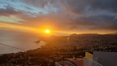 a view of the sun setting over the ocean at Villa das Furnas in Funchal