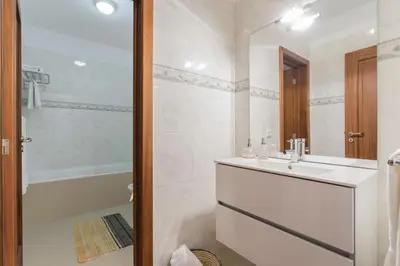 a white bathroom with a sink and a shower at Achada I by An Island Apart in Funchal