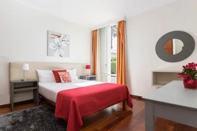 a bedroom with a bed with a red blanket at Achada I by An Island Apart in Funchal