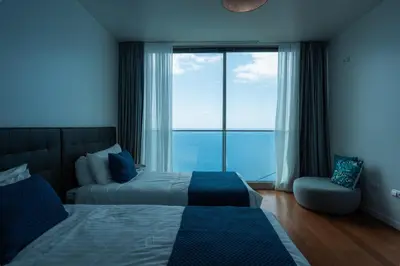 a bedroom with a bed and a large window at Sea View Villa Mar Lindo nr Ponta do Sol in Ponta do Sol