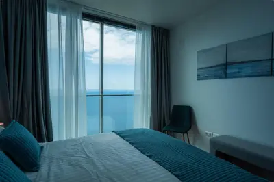 a bedroom with a bed and a large window at Sea View Villa Mar Lindo nr Ponta do Sol in Ponta do Sol