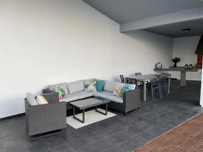 a living room with a couch and a table at Sea View Villa Mar Lindo nr Ponta do Sol in Ponta do Sol
