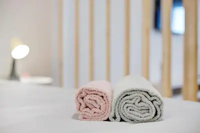 a pair of towels sitting on top of a bed at Babosas Charm in Funchal