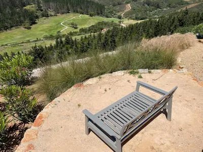 a bench sitting on top of a hill at Stunning Villa with Pool & View near beach in Budens
