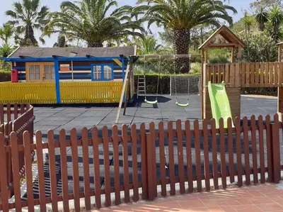 a playground behind a fence with a playground at Stunning Villa with Pool & View near beach in Budens