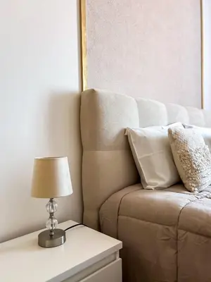 a lamp on a table next to a couch at The Pink Villa - Holidays in Madeira Island in Caniço