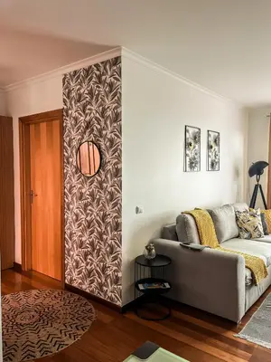 a living room with a couch and a wall at The Pink Villa - Holidays in Madeira Island in Caniço