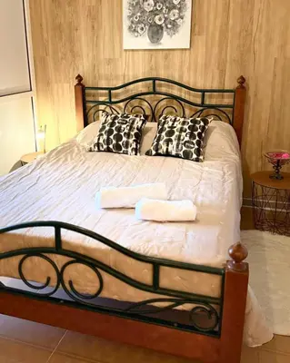 a bedroom with a bed with two towels on it at Ocean Hill House by Rentery Madeira in Santa Cruz
