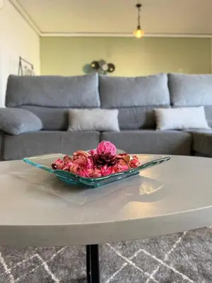 a living room with a television and a vase with flowers at Ocean Hill House by Rentery Madeira in Santa Cruz