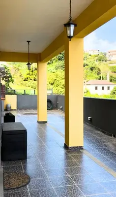 a bathroom with a bath tub on a balcony at Ocean Hill House by Rentery Madeira in Santa Cruz