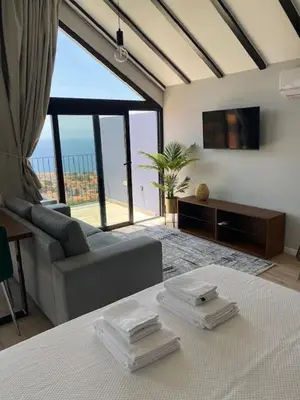 a living room with a couch and a tv at Atlântico Azul in Funchal