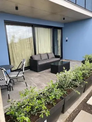 a patio with a couch and a table and chairs at Atlântico Azul in Funchal