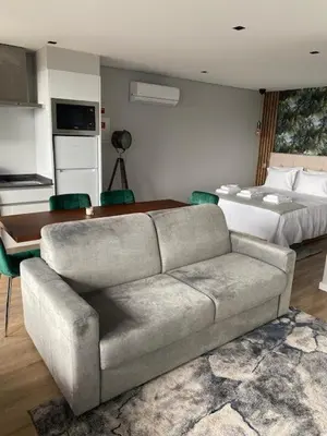 a living room with a couch and a bed at Atlântico Azul in Funchal