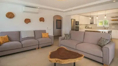 a living room with two couches and a coffee table at Peaceful Ocean View Villa in Luz