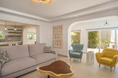 a living room with a couch and a table at Peaceful Ocean View Villa in Luz