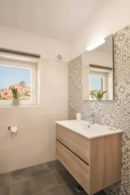 a bathroom with a sink and a mirror at Peaceful Ocean View Villa in Luz