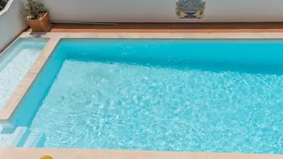 a large blue swimming pool with blue water at Peaceful Ocean View Villa in Luz