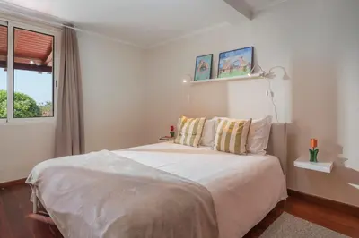 a bedroom with a large bed and a window at Casa Frangipani by An Island Apart in Santa Cruz