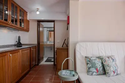 a living room with a couch and a kitchen at Casa Frangipani by An Island Apart in Santa Cruz