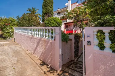 a pink gate in front of a fence at Casa Frangipani by An Island Apart in Santa Cruz