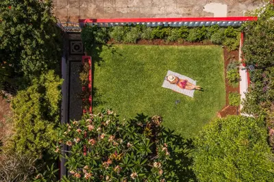 an overhead view of a garden with a person laying on a lawn at Casa Frangipani by An Island Apart in Santa Cruz