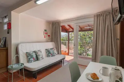 a living room with a couch and a table at Casa Frangipani by An Island Apart in Santa Cruz
