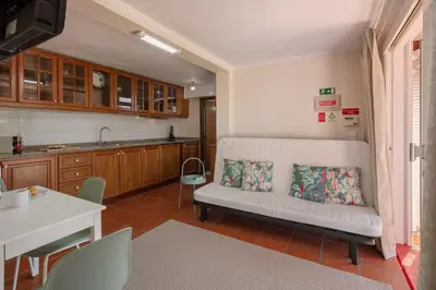 a living room with a white couch in a kitchen at Casa Frangipani by An Island Apart in Santa Cruz