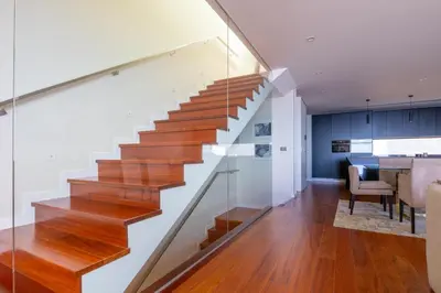 a staircase in a house with wooden floors and a dining room at Tiz house in Funchal