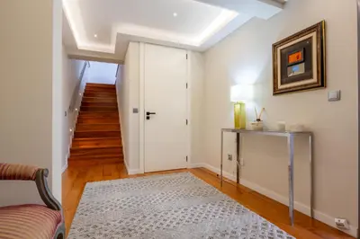 a living room with a white door and a rug at Tiz house in Funchal